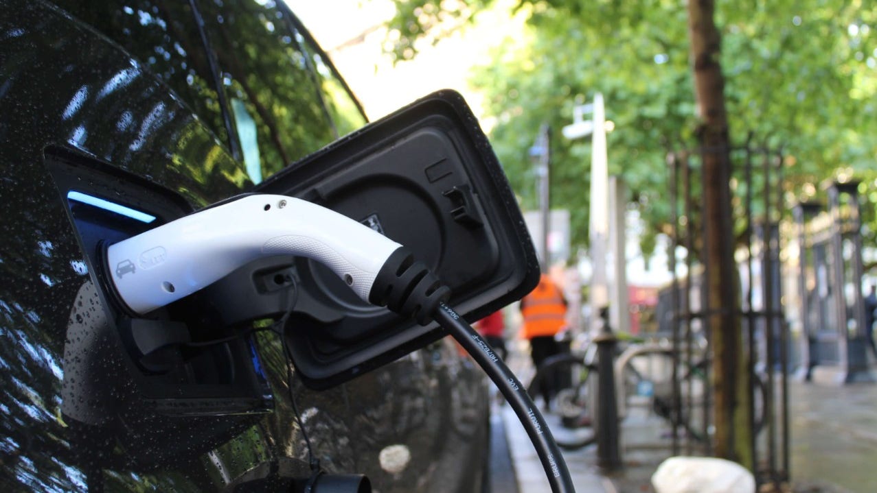 An electric vehicle is connected to a charging station.